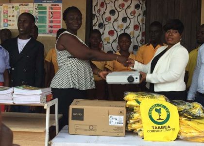 Mrs. Clara Akua Agyemang presents items to school